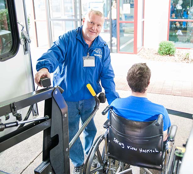 Man helping man in wheelchair